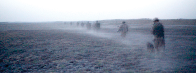 Oscar Company just after dawn, crossing a field near Chalghowr. [PHOTO: ADAM DAY]