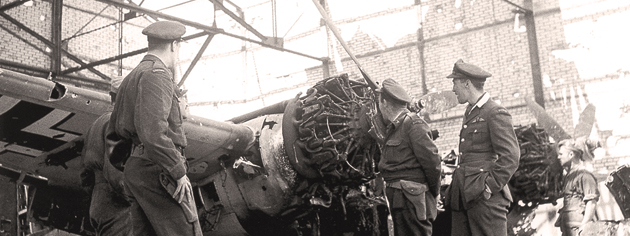 Allied officers examine a damaged German aircraft at Carpiquet airport in Normandy, July 1944. [PHOTO: KEN BELL, LIBRARY AND ARCHIVES CANADA—PA162519]