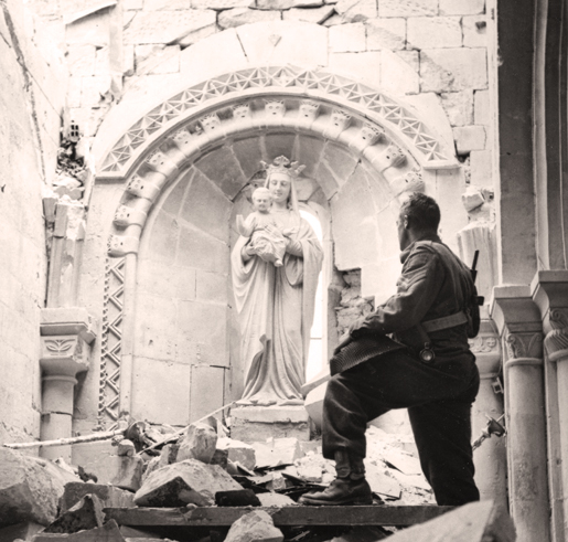 A Canadian soldier inside the ruins of a church at Carpiquet. [PHOTO: LEGION MAGAZINE ARCHIVES]