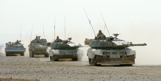Two Leopard tanks lead a convoy of armoured vehicles west of Kandahar, Afghanistan, December 2006. [PHOTO: SERGEANT DENNIS POWER, ARMY NEWS-SHILO]