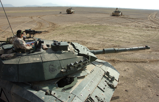 While in the turret of his Leopard tank, a tanker provides security for other armoured vehicles in Kandahar Province, Afghanistan, December 2006. [PHOTO: SERGEANT DENNIS POWER, ARMY NEWS-SHILO]