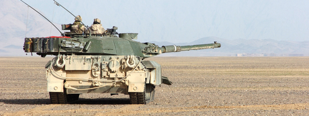 A Leopard tank of the Lord Strathcona’s Horse provides protection for a defensive formation of vehicles in Kandahar Province, Afghanistan, December 2006. [PHOTO: SERGEANT DENNIS POWER, ARMY NEWS-SHILO]