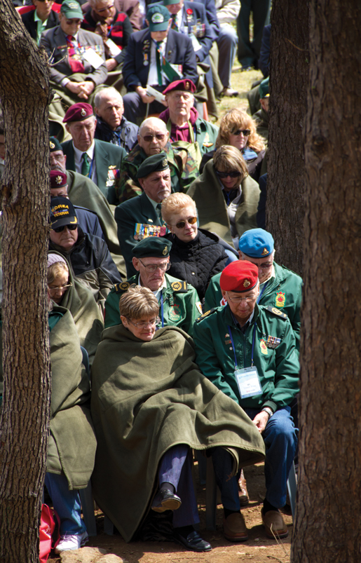 Veterans and their spouses and caregivers cover up during a chilly remembrance service at Gloster Hill. [PHOTO: DAN BLACK]