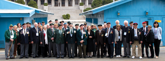 Dozens of Canadian veterans and caregivers pose in the Joint Security Area of the Demilitarized Zone. [PHOTO: DAN BLACK]
