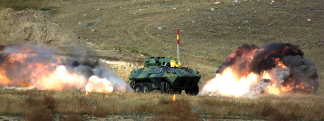 An IED blast rocks a Cougar, one of the armoured vehicles used by the Canadian Forces, in a test on the Suffield Experimental Proving Ground. [PHOTO: PHOTO GROUP, DRDC Suffield]
