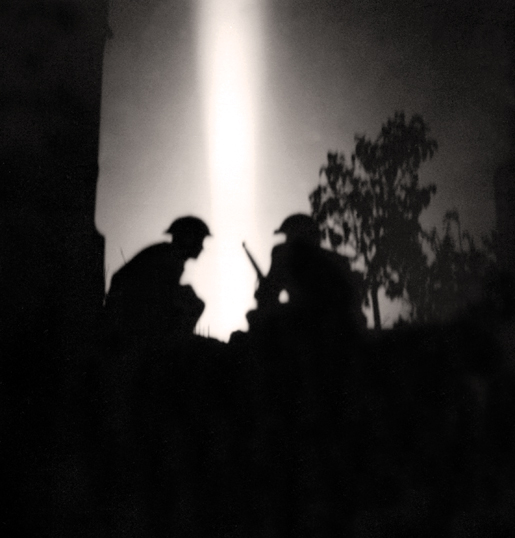 Silhouettes of Canadian infantry during the July 25, 1944, night attack. [PHOTO: MICHAEL M. DEAN, LIBRARY AND ARCHIVES CANADA—PA131384]