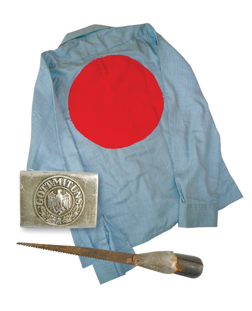 Memorabilia collected from the camps include a shirt with a red circle indicating a prisoner, a German Army buckle and a homemade knife discovered in Camp 133 at Lethbridge. [PHOTO: HOMEFRONT ARCHIVES & MUSEUM, REGINA; GALT MUSEUM & ARCHIVES, LETHBRIDGE, ALTA.]