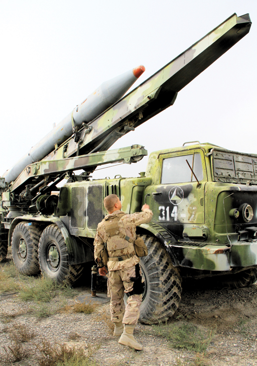 A 3rd Battalion, PPCLI, soldier inspects an abandoned Russian missile launcher in Kabul. [PHOTO: ADAM DAY]