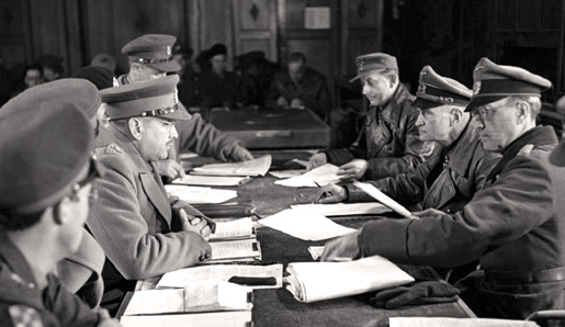 Lieutenant-General Charles Foulkes (left centre), GOC 1st Canadian Corps, accepts the surrender of German forces.