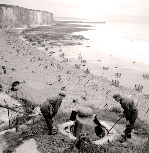 Enemy fortifications are examined two years after the raid. [PHOTO:  KEN BELL, LIBRARY AND ARCHIVES CANADA—PA134448]