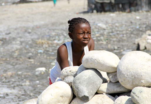 A girl watches children play in Cité Soleil, Port-au-Prince, Haiti. [PHOTO: DAN BLACK]