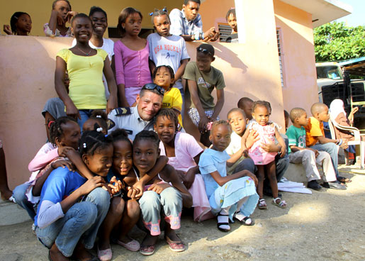 RCMP Staff Sergeant Richard Martel spends quality time with children at the orphanage. [PHOTO: DAN BLACK]