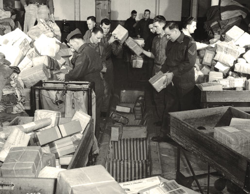 Members of the Canadian Postal Corps sort parcels at the Base Post Office. [POST OFFICE DEPARTMENT, LIBRARY AND ARCHIVES CANADA—PA061630]