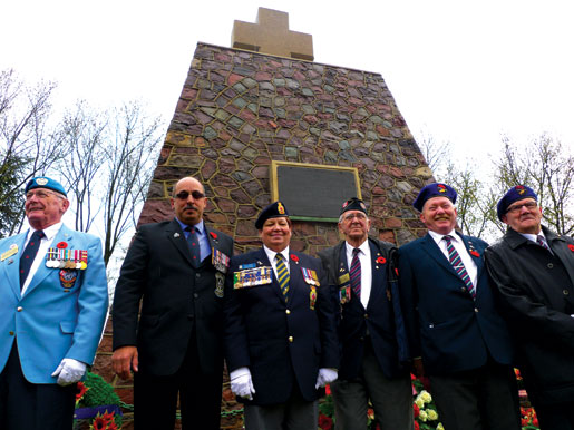 Veterans Robert O’Brien, Reno St-Germain, Dominion President Pat Varga, Neil McKinnon, caretaker Edward Corbett and Gene Heesaker at the memorial in Thélus.
