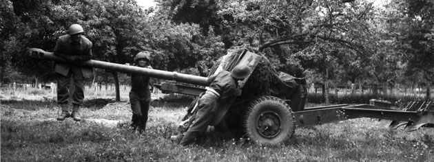 A 17-pounder anti-tank gun is moved into position, June 1944. [PHOTO: KEN BELL, LIBRARY AND ARCHIVES CANADA—PA128793]