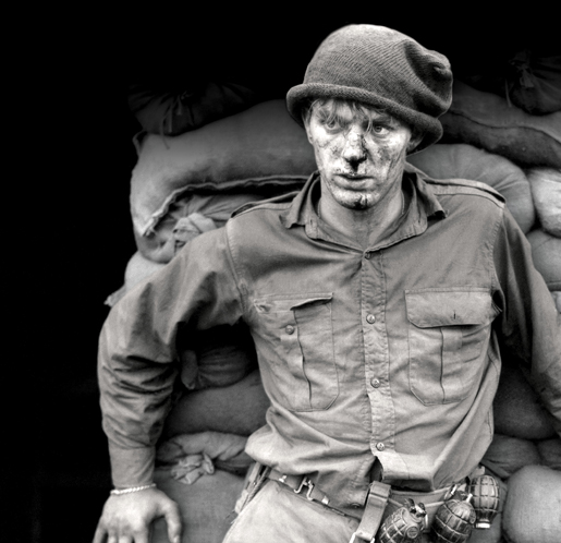 Following a night patrol in Korea, Private Heath Matthews of 1st Battalion, Royal Canadian Regiment awaits medical attention outside a regimental aid post, June 1952. Authorized by Moscow with Communist China concurrence, the Korean War led to rearmament in the West. [PHOTO: PAUL TOMELIN, LIBRARY AND ARCHIVES CANADA—PA128850]
