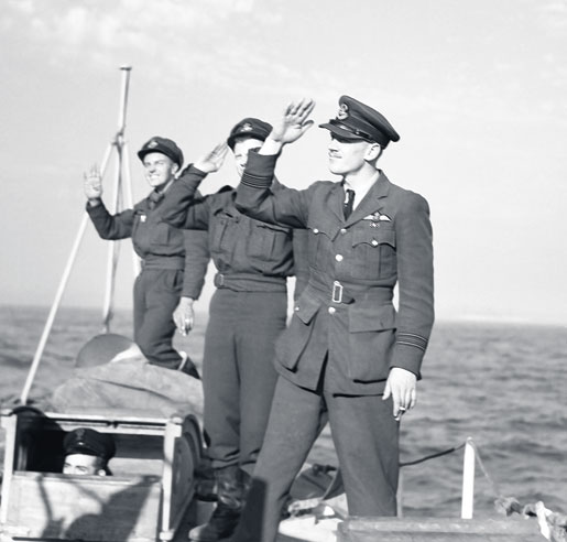 Squadron Leader Wally McLeod and two other pilots salute sailors as they pull away from HMS Rodney in 1944. The airmen visited the ship during some free time from operations in Normandy. [PHOTO: CANADIAN FORCES JOINT IMAGERY CENTRE—PL30668]