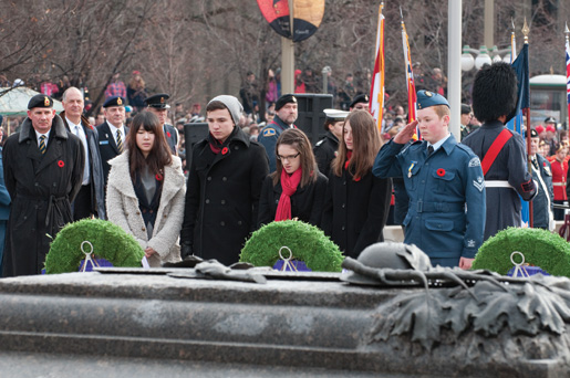Dominion Secretary Brad White (left) looks on as youth representatives (from left) Sienna (Jeong Eun) Cho, Owen Brown, Allison Somers and Amelia Haines place a wreath. [PHOTO: MARC FOWLER & RANDY HARQUAIL/METROPOLIS STUDIO]