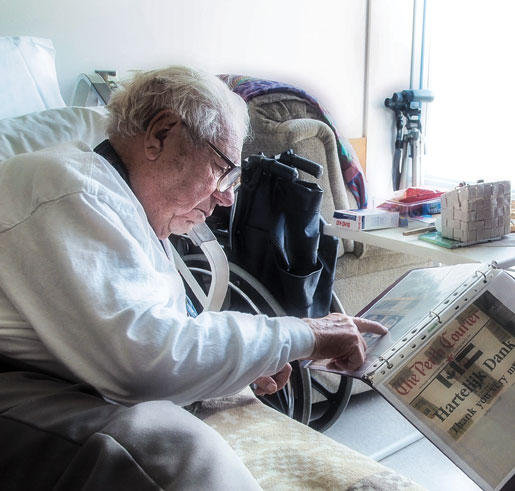 A newspaper clipping brings back some memories for Ted. [PHOTO: DAN WARD]