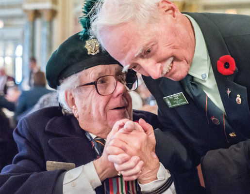 Ted and a fellow veteran shake hands during the lunch at the Fairmont Chateau Laurier Hotel. [PHOTO: DAN WARD]