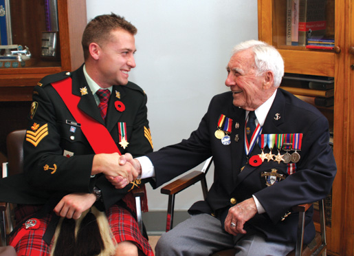 Sgt. Josh Jensen and veteran Bob Hughes meet. [PHOTO: SHARON ADAMS]