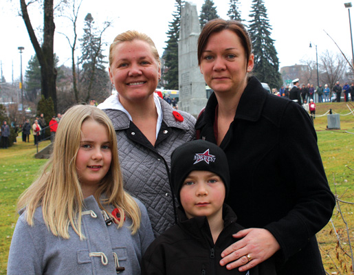 Sisters Rhonda Turner-Kavcar (left) and Chrissie Dysevick bring Megan and Cody to the service. [PHOTO: SHARON ADAMS]