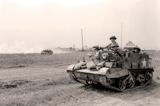 A Universal Carrier advances near Cintheaux, France, August 1944. [PHOTO: KEN BELL, LIBRARY AND ARCHIVES CANADA—PA113651]