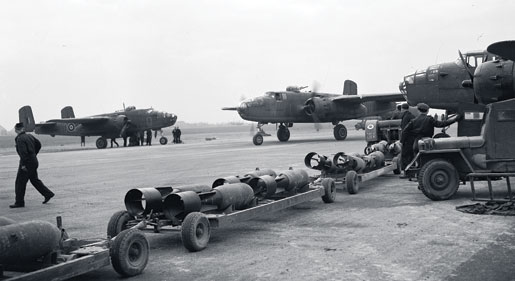 A fresh supply of bombs awaits incoming Mitchell bombers, March 1945. Fuelling and bomb-loading operations sometimes began even before crews alighted from the aircraft. [PHOTO: CANADIAN FORCES JOINT IMAGERY CENTRE—PL42718]