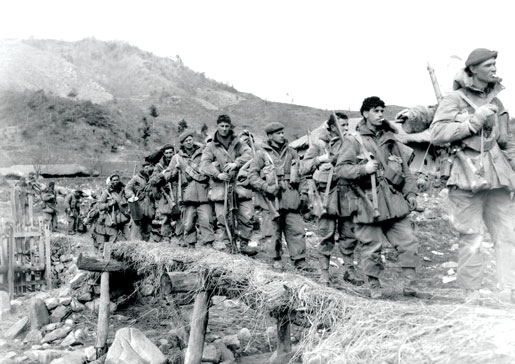 Troops of 2nd Battalion, Princess Patricia’s Canadian Light Infantry cross a log bridge in Korea, February 1951. [PHOTO: LIBRARY AND ARCHIVES CANADA—PA115034]