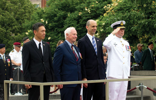 Taking the salute during the parade are (from left) Wan-Geun Choi of South Korea, Governor General David Johnston, Veterans Affairs Minister Steven Blaney and Vice-Admiral Mark Norman. [PHOTO: TOM MACGREGOR]