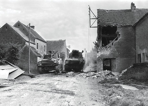 Tanks of the South Alberta Regiment—one apparently crippled—in St. Lambert-sur-Dives, Normandy, August 1944. [PHOTO: DONALD I. GRANT, LIBRARY AND ARCHIVES CANADA—PA116522]