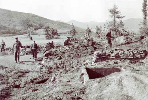 Following a Chinese attack, the 2nd Royal Canadian Regiment searches a suspected hideout.[PHOTO: LIBRARY AND ARCHIVES CANADA—PA183960]