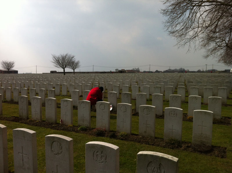 Michael O’Sullivan pays his respects at Poelcappelle British Cemetery. [PHOTO: TOM O’SULLIVAN]