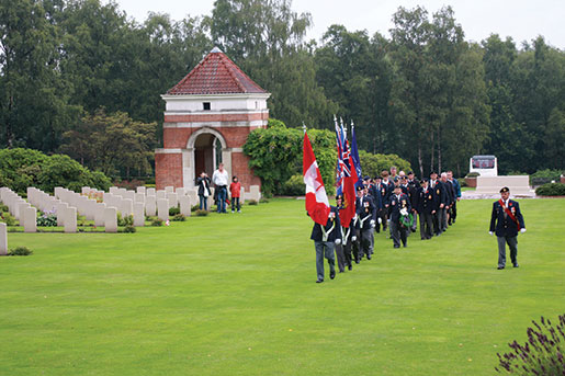 A colour party prepares for a memorial service during a Legion Youth Leaders’ Pilgrimage of Remembrance at Holten Canadian War Cemetery near Deventer, Netherlands, 2009. [PHOTO: SHARON ADAMS, LEGION MAGAZINE]