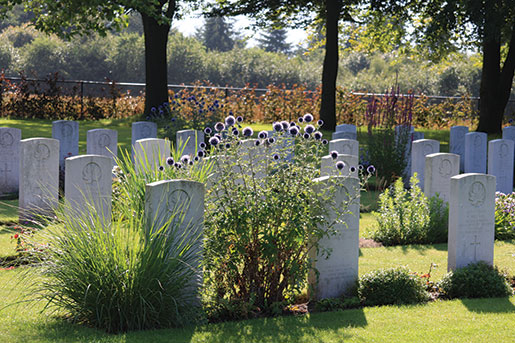 Canadian graves flank carefully tended flowers in Groesbeek Canadian War Cemetery near Nijmegen, Netherlands. [PHOTO: SHARON ADAMS, LEGION MAGAZINE]