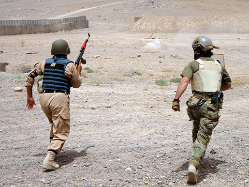 A CSOR operator conducts live-fire training with an Afghan counterpart. [PHOTO: DEPARTMENT OF NATIONAL DEFENCE]
