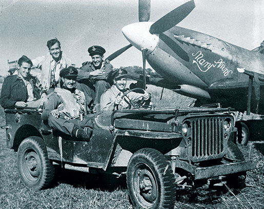 Squadron Leader Robert Day behind the wheel of a jeep, joined by other Far East personnel. [PHOTO: LIBRARY AND ARCHIVES CANADA—e011086438]