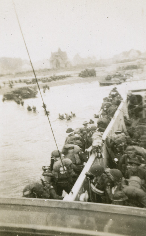 Canadian soldiers head into the water from a landing craft at Bernières-sur-Mer, June 6, 1944. [PHOTO: CANADIAN WAR MUSEUM—20020039-001_3c]
