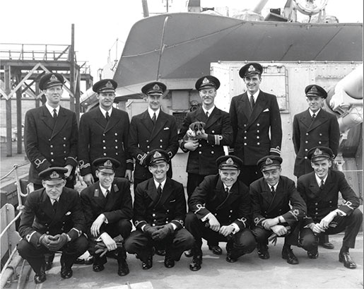 Officers of HMCS Assiniboine, including Lieutenant-Commander J.H. Stubbs (holding the dog), pose in St. John’s, Nfld.,  August 1942, following the sinking of U-210. [PHOTO: DEPARTMENT OF NATIONAL DEFENCE, LIBRARY AND ARCHIVES CANADA—PA116283]