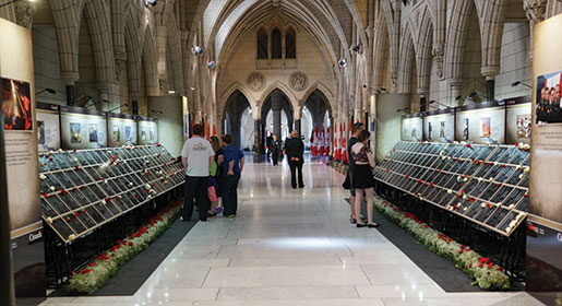 Visitors view the Afghanistan Memorial Vigil in the Parliament Buildings in Ottawa. [PHOTO: ADAM DAY]