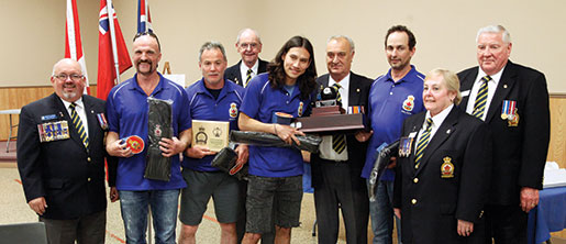 Dominion Command Sports Committee representative Mike Atkinson (centre) presents the team trophy to (from left in team shirts) Pete Holden, Brad Douglas, Dylan Thomas and Craig Walters. Looking on (from left) are Dominion First Vice Dave Flannigan, District A sports officer Dave Roe, Gloria McKibbin and Ontario Sports Chairman Vic Newey. [PHOTO: ADAM DAY]