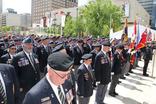 Heads bow in silence during the wreath-placing ceremony. [PHOTO: LEGION MAGAZINE]