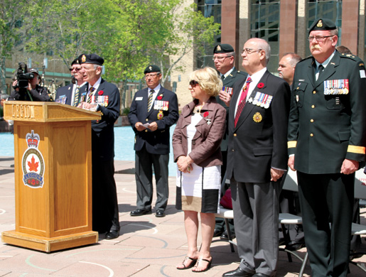 Grand President Larry Murray speaks as National Silver Cross Mother Niki Psiharis, Veterans Affairs Minister Julian Fantino and Brigadier-General Dave Anderson look on. [PHOTO: LEGION MAGAZINE]