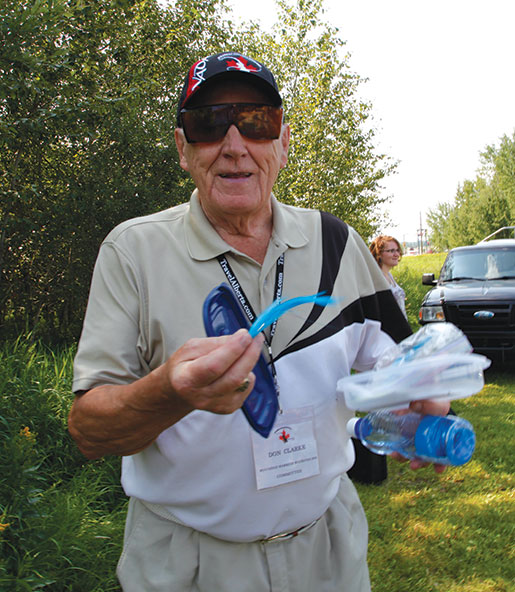 Alberta organizer Don Clarke shows off a special fishing lure. [PHOTO: ADAM DAY]