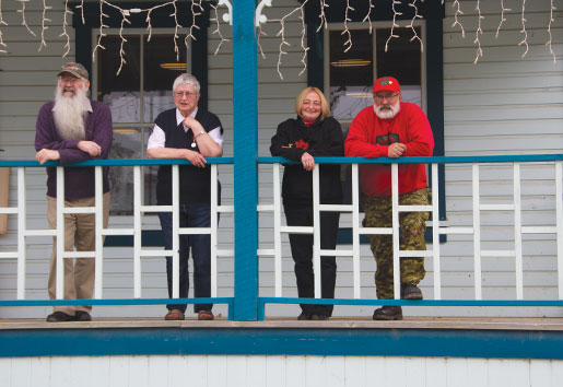 Relaxing on the veranda of Dawson City Branch are members (from left) Chris Collin, Myrna Butterworth, President Diane Baumgartner and John Mitchell. [PHOTO: Tom MacGregor]
