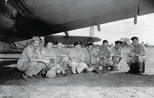 Canadian aircrew of No. 194 Squadron escape the hot sun by finding shade beneath the wing of an aircraft, April 1943. [PHOTO: LIBRARY AND ARCHIVES CANADA—PL-18001]