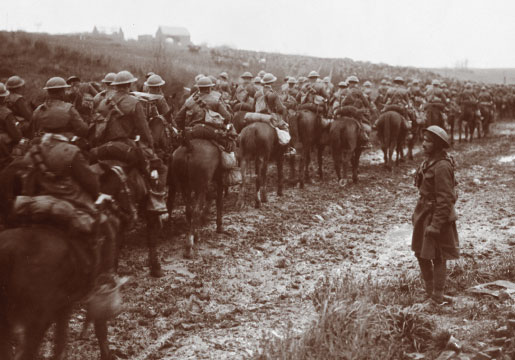 A squadron of the Fort Garry Horse passes a village, February 1918. [PHOTO: DEPARTMENT OF NATIONAL DEFENCE, LIBRARY AND ARCHIVES CANADA—PA002493]