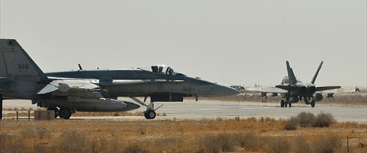 Royal Canadian Air Force CF-18 fighter jets taxi to the runway in Kuwait in support of combat missions over Iraq in November. [PHOTO: CANADIAN FORCES COMBAT CAMERA]
