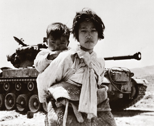 Korean child carrying her small brother, Korea, 1951. [PHOTO: UN MULTIMEDIA—78321]