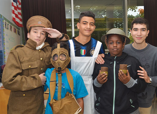 Ottawa students try on artifacts from a First World War Discovery Box. [PHOTO: ELLEN O’CONNOR]